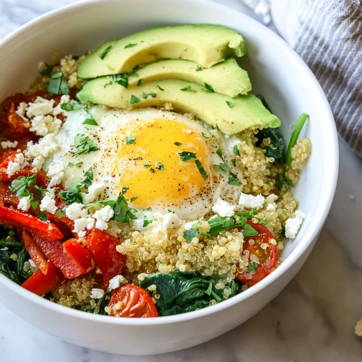 Warm Savory Quinoa Breakfast Bowl loaded with sautéed peppers, spinach, and creamy avocado