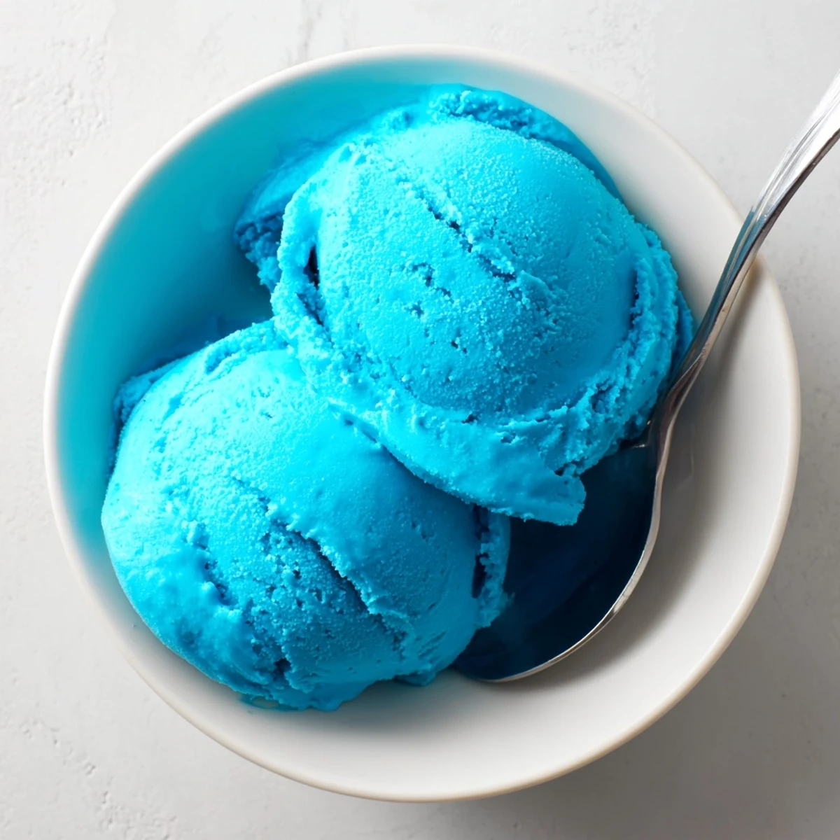 Creamy Blue Moon ice cream scooped into a crispy waffle cone with colorful sprinkles