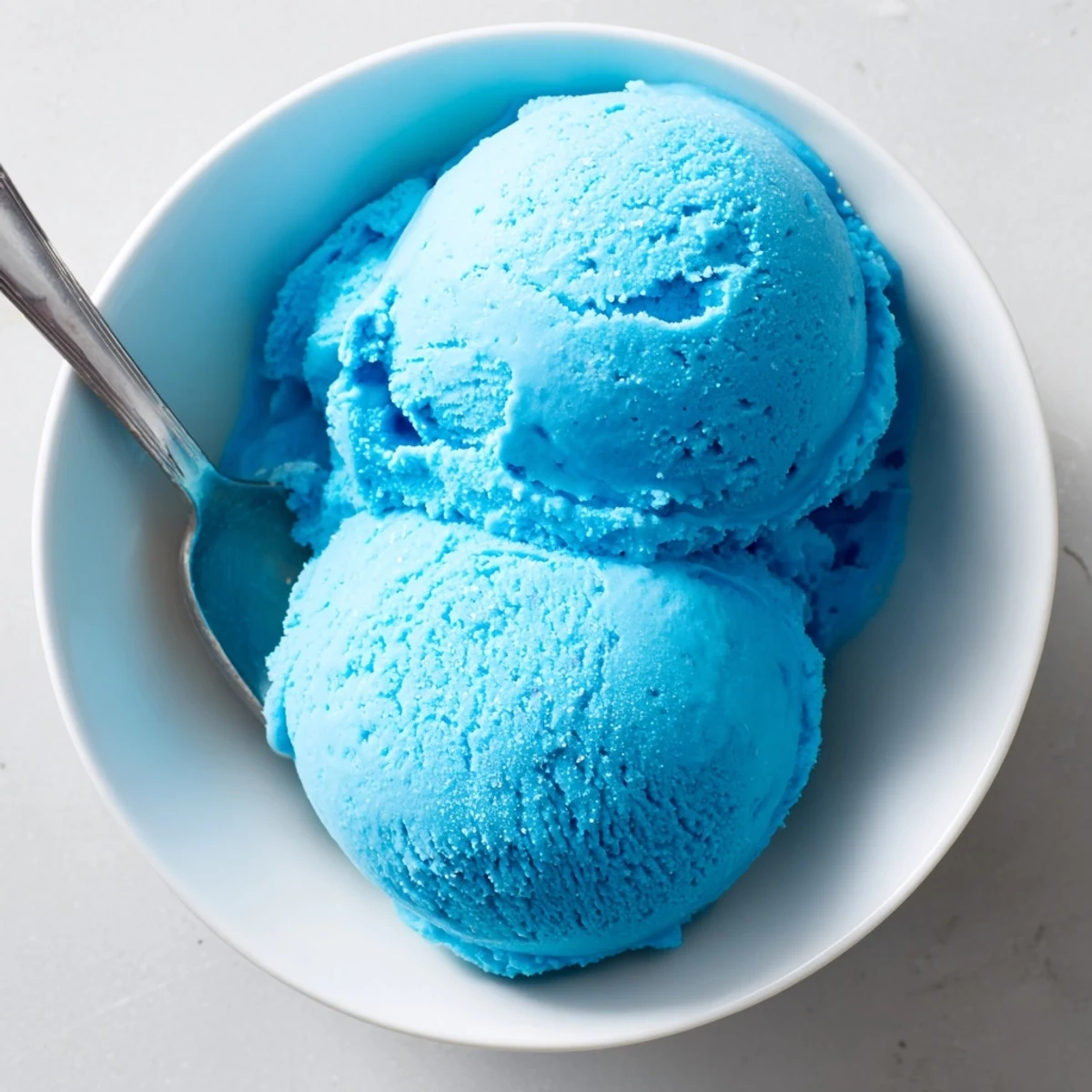 Smooth homemade blue moon ice cream with a swirl of bright vivid color