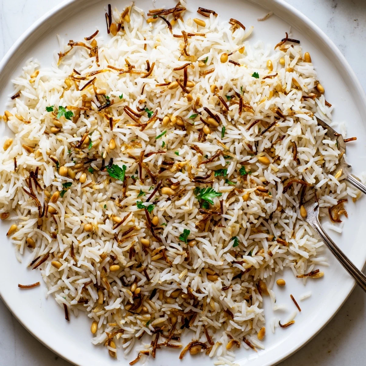Steaming plate of buttery Lebanese Rice alongside grilled chicken and vegetables