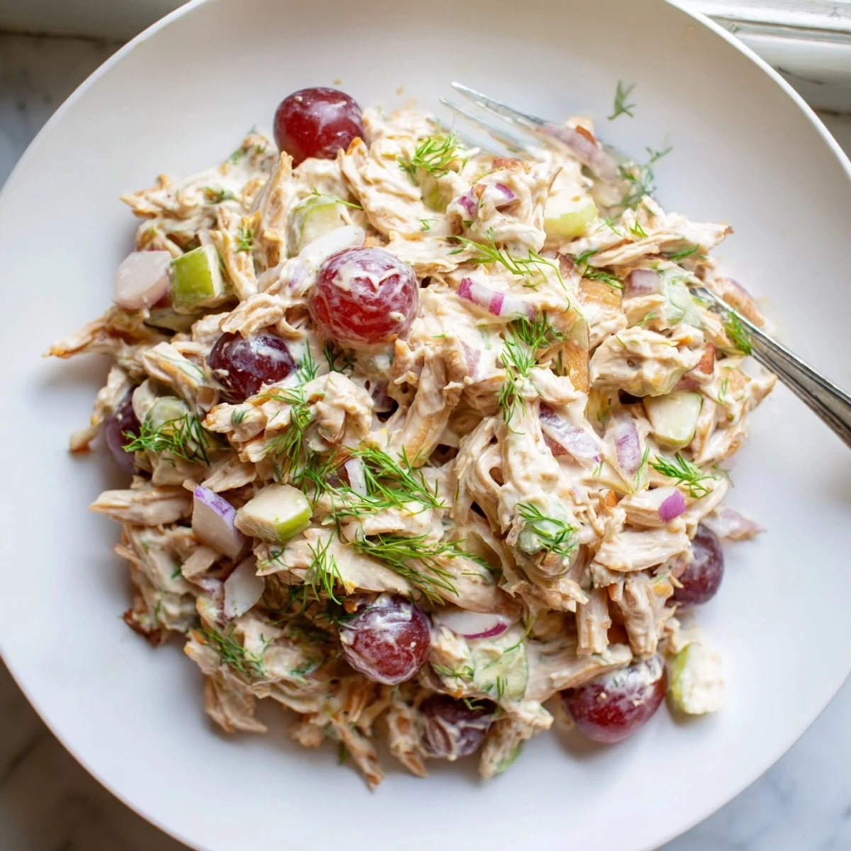 Creamy vegan chicken salad piled on toasted bread with crisp celery and fresh herbs