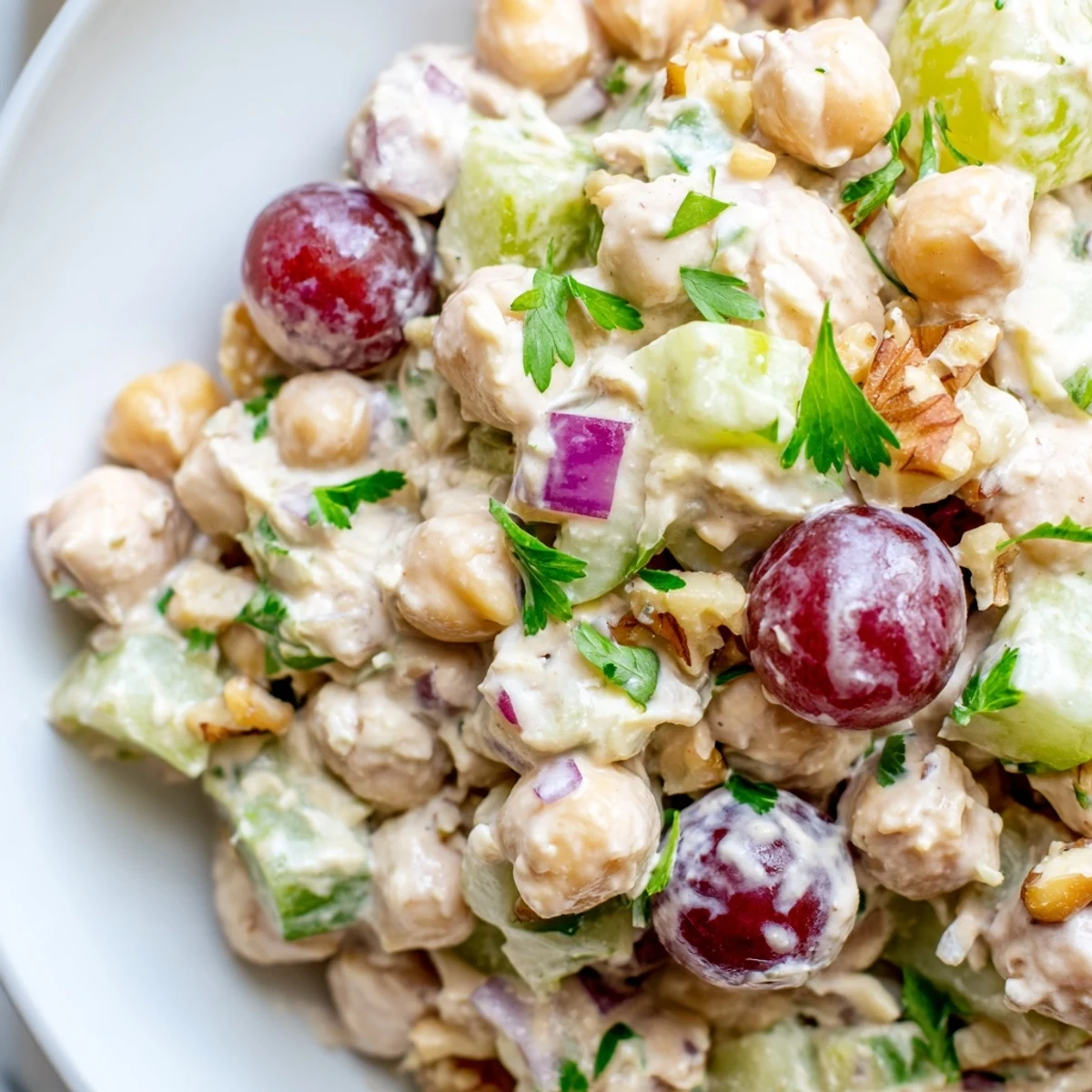 Creamy vegan chicken salad piled on toasted bread with crisp celery and fresh herbs