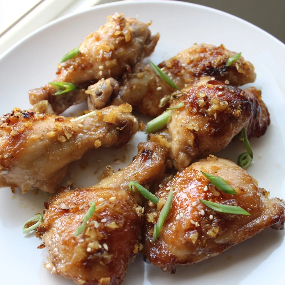 Golden ginger garlic chicken thighs baked until crispy on a sheet pan