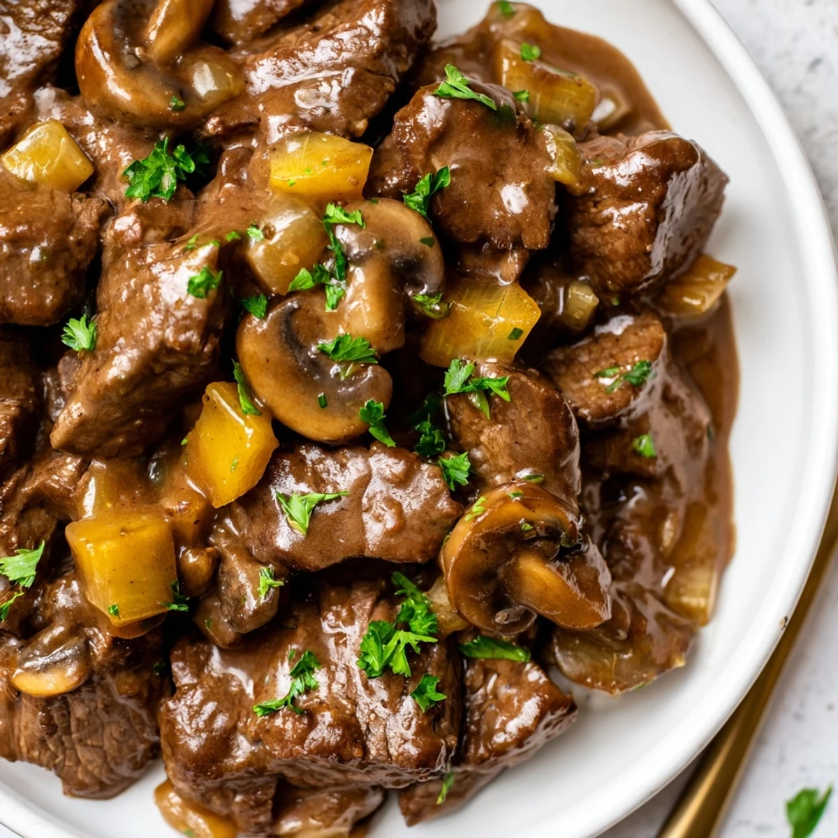 Tender weeknight steak tips and gravy smothered over creamy mashed potatoes