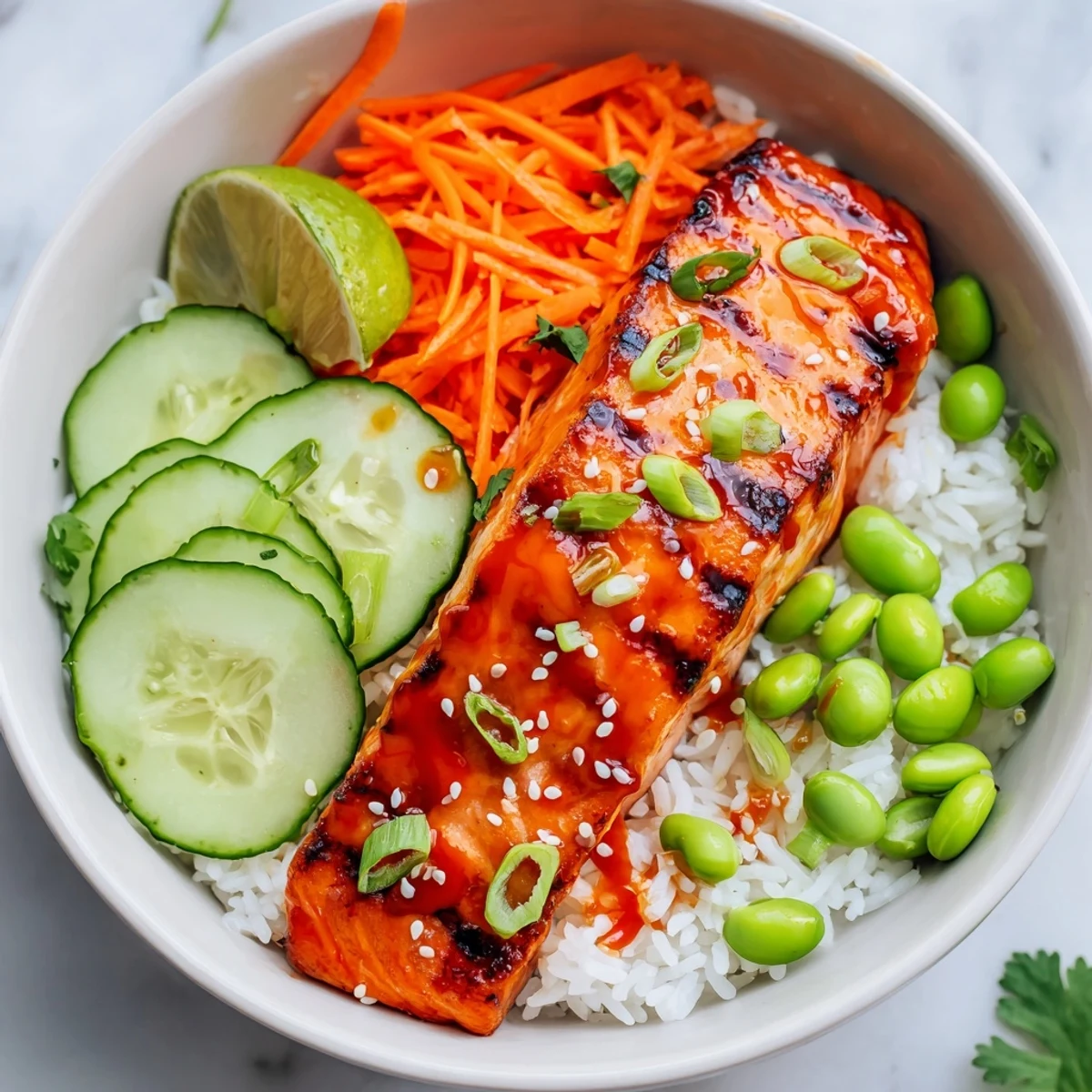 Glistening sriracha honey glazed salmon bowls with colorful crisp vegetables over steamed white rice