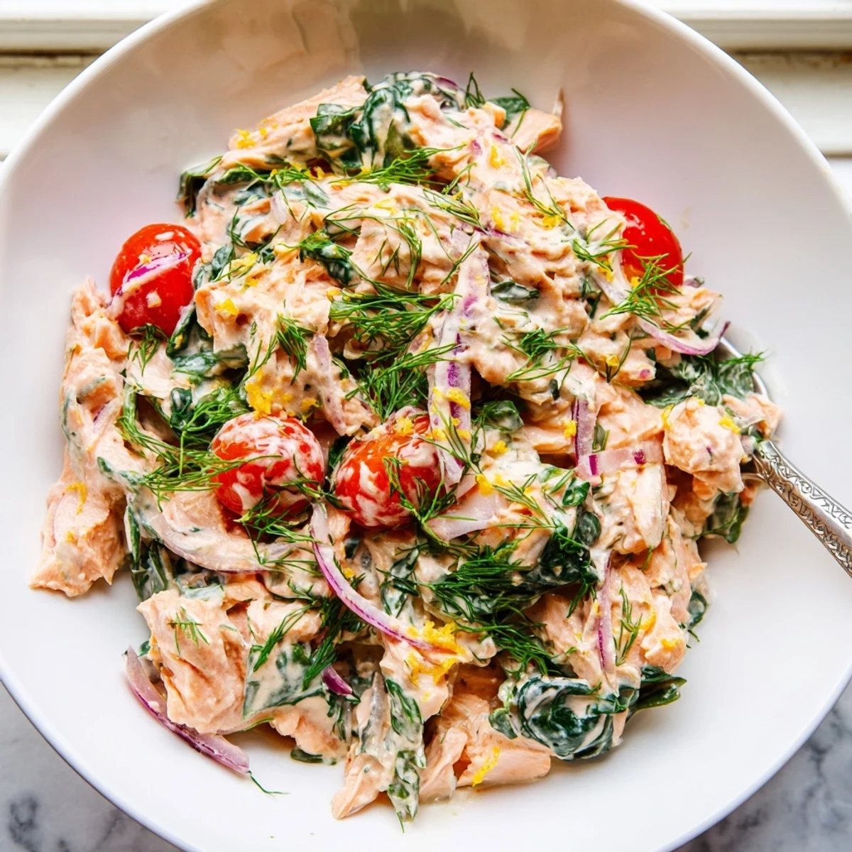 Healthy creamy leftover salmon recipe topped with fresh chives and bright lemon zest