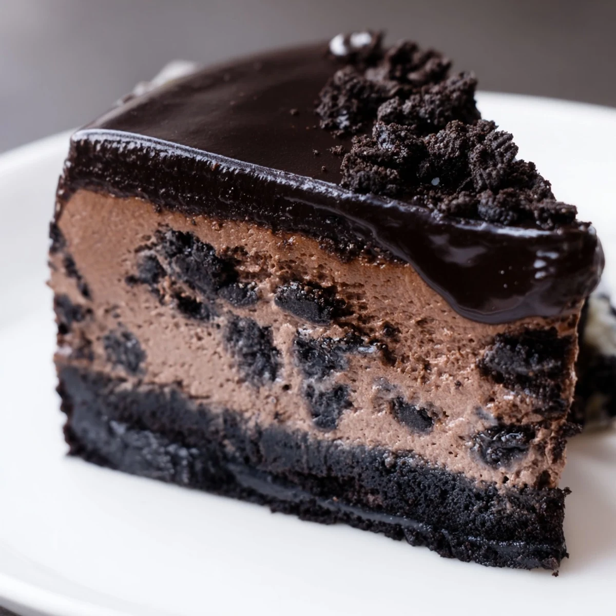 Decadent Oreo chocolate cheesecake drizzled with smooth ganache and sprinkled with crushed cookies