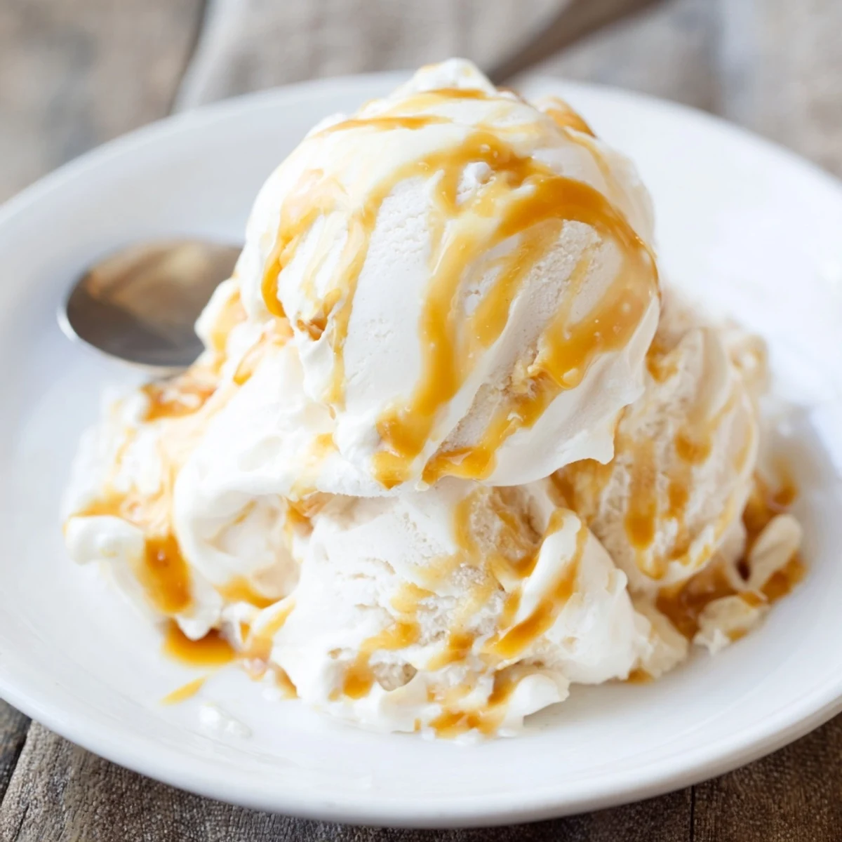 Smooth halal salted caramel ice cream served in a bowl with luscious caramel swirls.