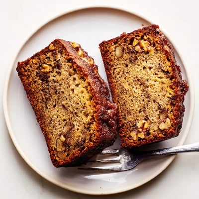 Golden super moist banana bread with a tender crumb fresh from the oven loaf pan