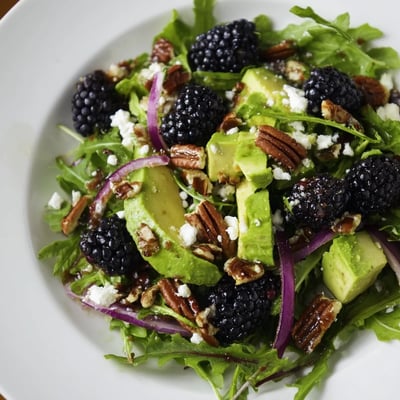 Creamy avocado and sweet blackberries tossed with arugula in this refreshing salad.  